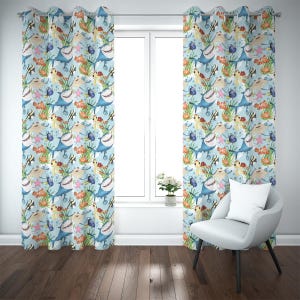 May include: Two light blue window curtains featuring a repeating pattern of cartoon sharks, fish, sea turtles, and coral. The curtains hang in front of a window, with a white chair and a small plant in the room.