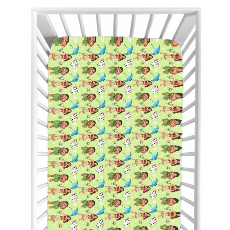 May include: A fitted cot sheet featuring a repeating pattern of a cartoon character, flowers, and umbrellas on a light green background. The sheet is inside a white cot.