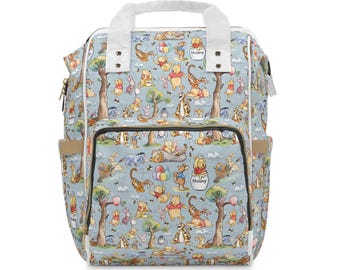 May include: A light blue backpack featuring a repeating pattern of Winnie the Pooh characters, including Tigger, Piglet, and Eeyore, among trees and balloons. The bag has white top handles, a front zippered pocket, and a pot labeled Hunny.