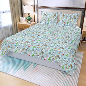 May include: A light blue bedspread and two pillowcases featuring a repeating pattern of cartoon characters. The bedding set has a white polka dot design and is placed on a bed with a white mattress.