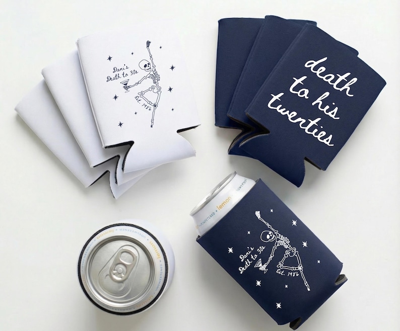 May include: White and navy blue can coolers with text and skeleton graphics. One cooler says "Dani's Death to 30s" and another says "death to his twenties". A silver can is in a navy blue cooler.