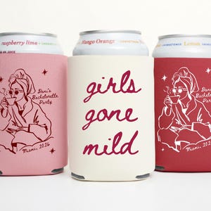 May include: Three beverage can coolers in pink, cream, and red. The pink and red coolers feature a line drawing of a woman in a robe, holding a cup. The cream cooler has the words "girls gone mild" in cursive. All coolers have text that reads "Dani's Bachelorette Party Miami, 2026".