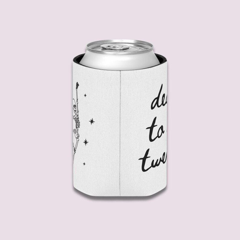May include: White can cooler with a black skeleton graphic and the words "dead to twenty" in black script. The cooler is holding a silver can.