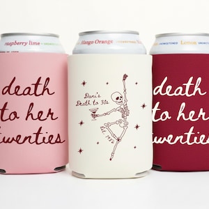 May include: Three beverage can coolers in pink, cream, and burgundy. The pink and burgundy coolers have the text "death to her twenties" in white script. The cream cooler features a skeleton illustration and the text "Dani's Death to 30s".