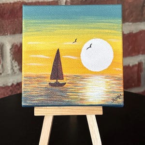 Sailboat in sunset acrylic painting with easel.