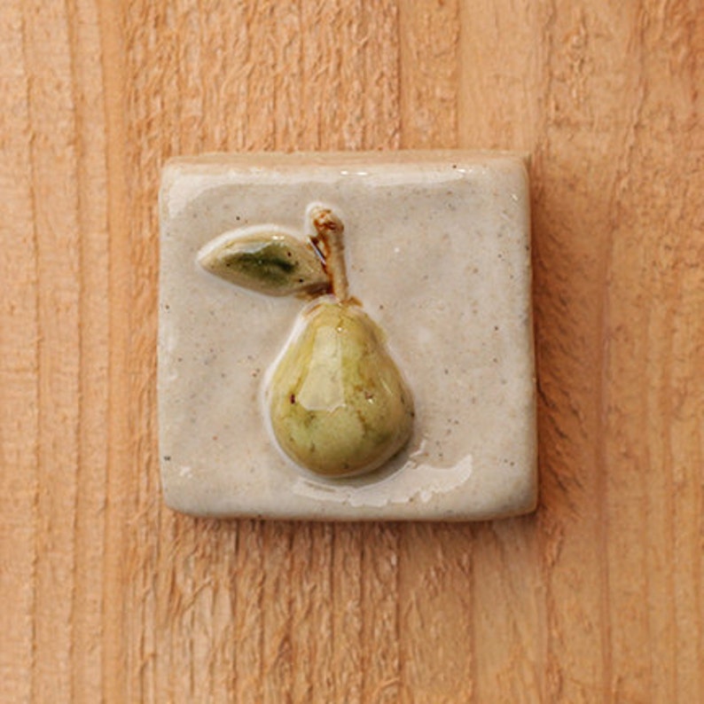 Handmade 2x2 ceramic pear tile comes with a hanger on the back or ready for a tile installation