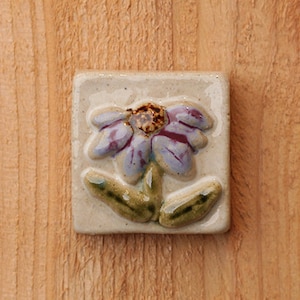 Handmade 2x2 ceramic purple coneflower tile comes with a hanger on the back