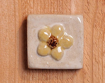 Handmade 2x2 ceramic yellow dogwood flower tile comes with a hanger on the back