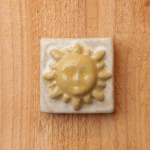 2x2" Handmade ceramic sun tile with hanger on the back for for tile installation