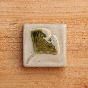 Handmade 2x2 ceramic ginkgo leaf tile comes with a hanger on the back