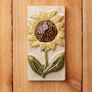 Handmade 3x6 ceramic tile with a yellow sunflower in relief comes with a hanger on the back or ready for a tile installation