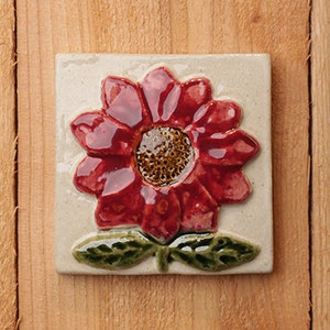 Handmade 4x4 ceramic red Daisy tile comes with a hanger on the back, suitable for tile installation