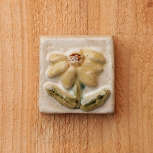 Handmade 2x2 ceramic yellow coneflower tile comes with a hanger on the back