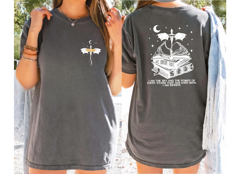 a woman wearing a gray t-shirt with a dragon design and a quote on the back.