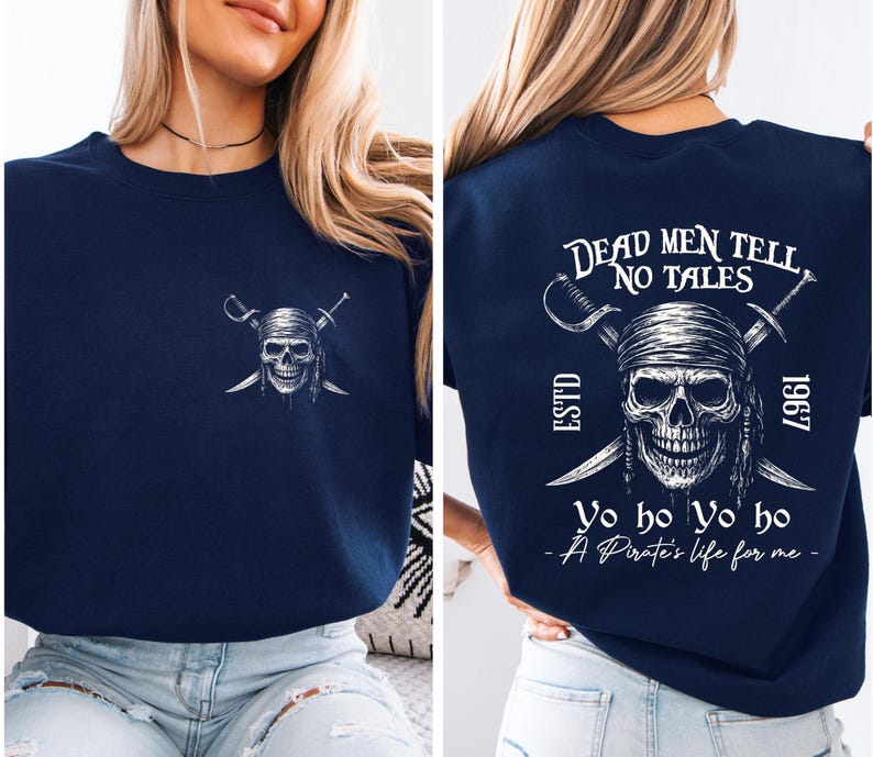 A woman wearing a navy blue t-shirt with a pirate-themed design on the back.