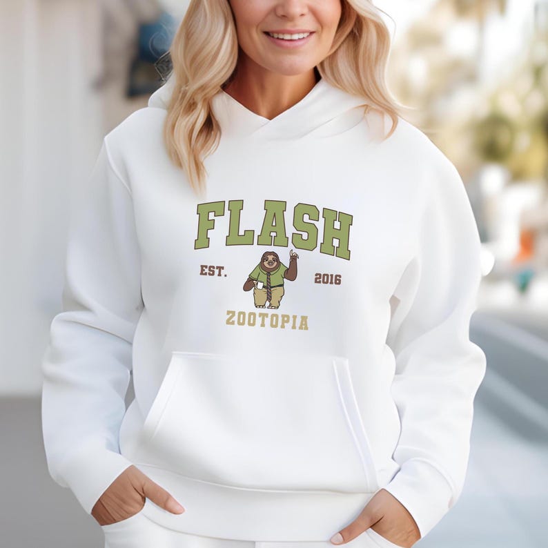 A woman wearing a white hoodie with a graphic design on it.