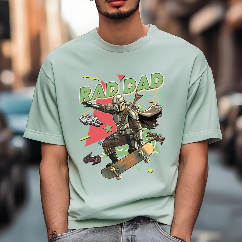 A man wearing a t-shirt with a graphic design featuring a character riding a skateboard and the text "RAD DAD".