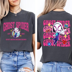 a woman wearing a black t-shirt with a graphic design of a character from the Spider-Man franchise.