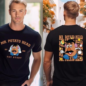 A man wearing a black t-shirt with a graphic of the character Mr. Potato Head from the Toy Story franchise.