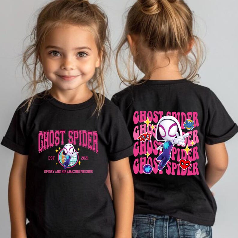 A young girl wearing a black t-shirt with a graphic of a spider character and text related to the character Ghost Spider.