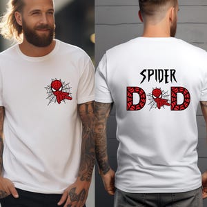 A man wearing a white t-shirt with a Spiderman design and the text "SPIDER DAD" printed on the back.
