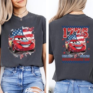 a woman wearing a t - shirt with cars on it