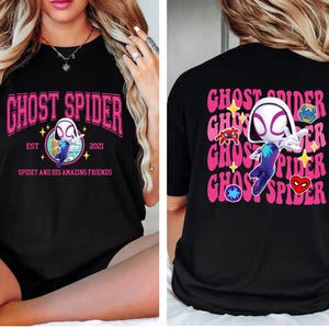 a woman wearing a black t-shirt with a graphic design of a spider character.