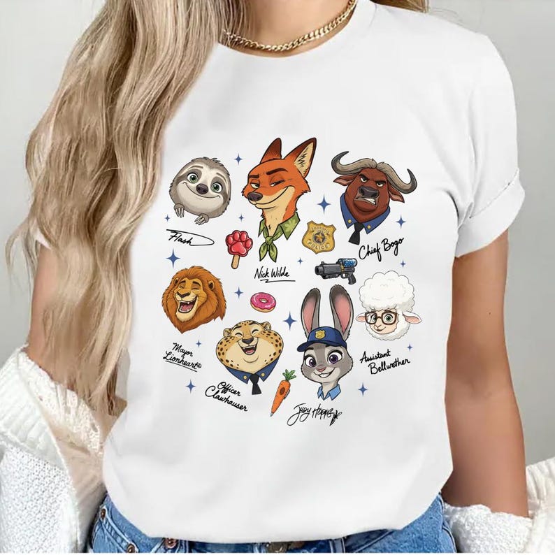 A white t-shirt with a graphic design featuring various cartoon animal characters and their names.