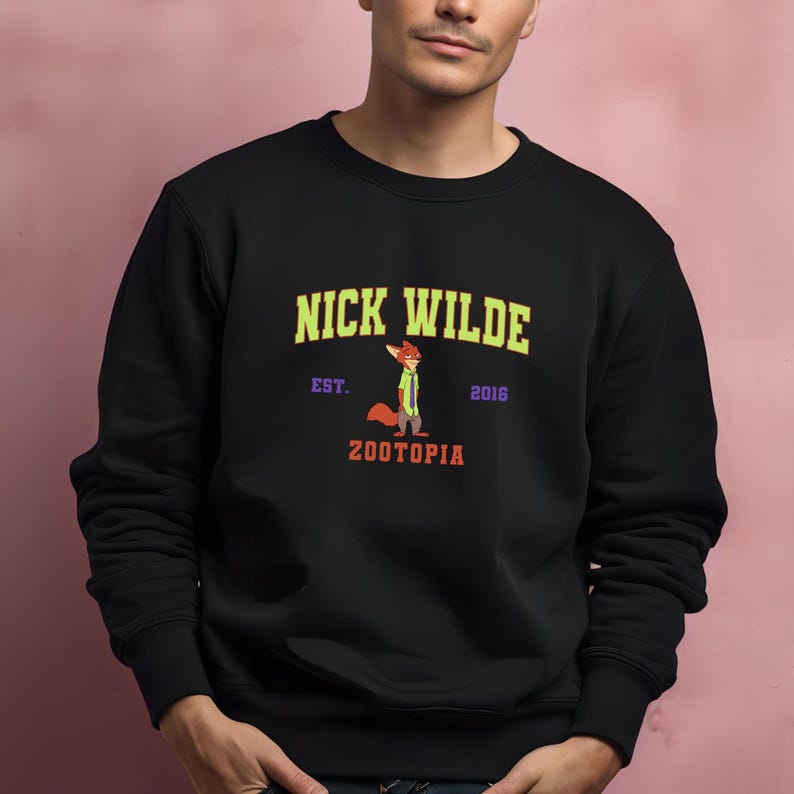 A man wearing a black sweatshirt with a graphic design featuring a cartoon character and text.