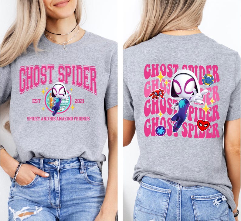 a woman wearing a grey t-shirt with a graphic design of a character from the Spider-Man franchise.
