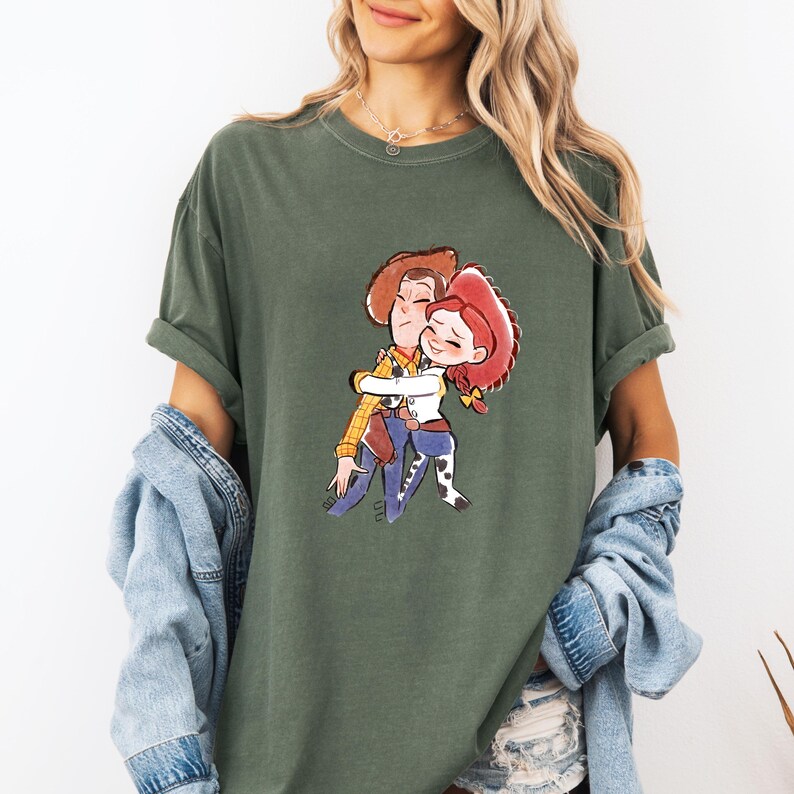 a woman wearing a t - shirt with a picture of two people hugging