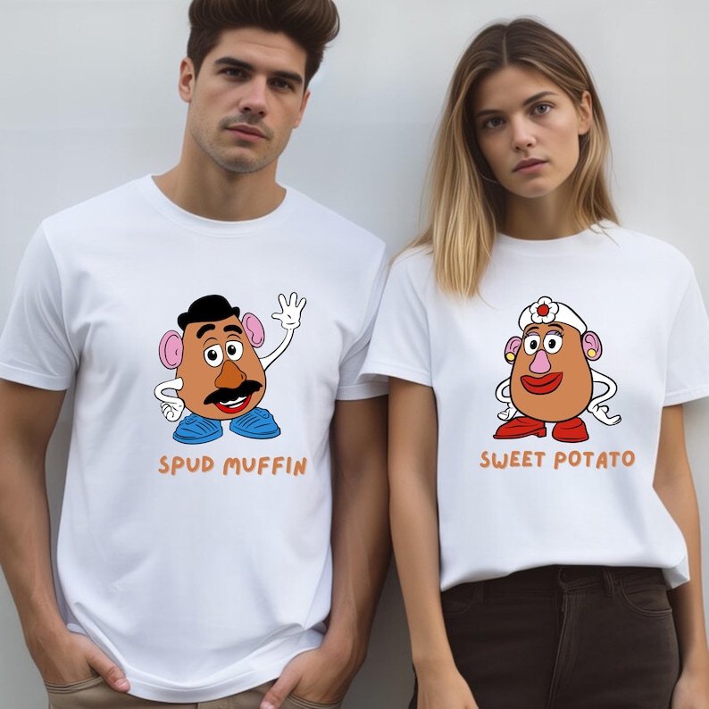 A man and a woman wearing white t-shirts with cartoon characters printed on them.