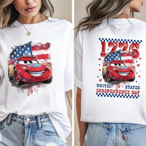 a woman wearing a white t - shirt with cars printed on it