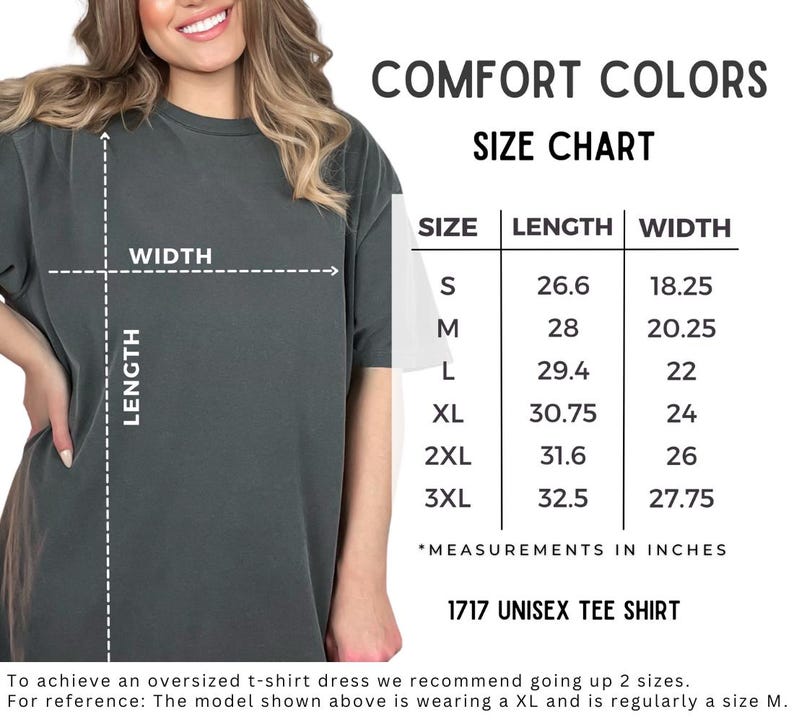 Puede incluir: Una camiseta unisex gris oscuro con una tabla de tallas. La tabla enumera las medidas en pulgadas para las tallas S a 3XL. Tambi&eacute;n se ve el texto "COMFORT COLORS" y "1717 UNISEX TEE SHIRT".