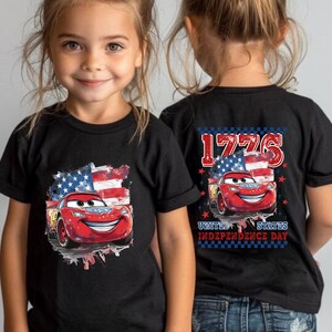 two little girls wearing matching cars t - shirts