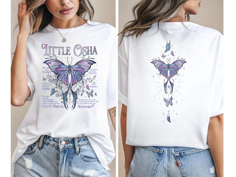 A woman wearing a white t-shirt with a butterfly design and text printed on it.