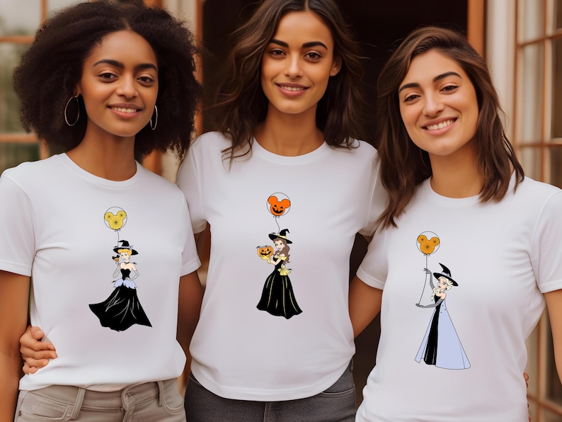 three women wearing t - shirts with cartoon characters on them