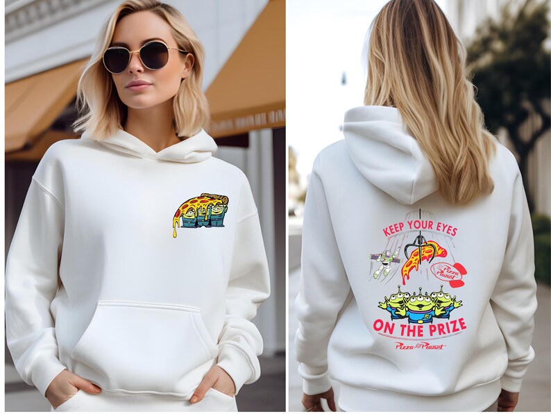 A woman wearing a white hoodie with a graphic design on the front and back.