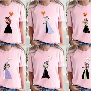 a woman wearing a pink shirt with cartoon characters on it