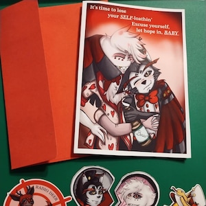 May include: A set of stickers featuring cartoon characters from the animated series Hazbin Hotel. The stickers include a red deer with antlers, a broken heart with two characters, and a yellow duck wearing a hat. The text on the stickers reads "Radio Deer" and "Season".