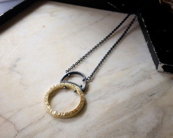 Hammered circle pendant 18k yellow gold and oxidized sterling silver