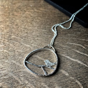 Modern sterling silver bird on a branch pendant