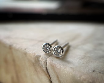 3mm Tiny bezel set round brilliant cut moissanite stud earrings set in sterling silver .25 carat tw