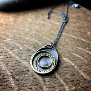 Oxidized sterling silver and 18k yellow gold concentric circles pendant Orbit