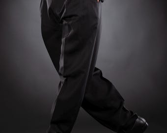 May include: A pair of black dress trousers with a subtle pinstripe pattern. The trousers have a high waist and a wide leg.