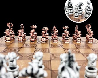 May include: A chess set with copper and silver pieces on a wooden board. The pieces are stylized animal figures, including a snake, a cat, and a bird.