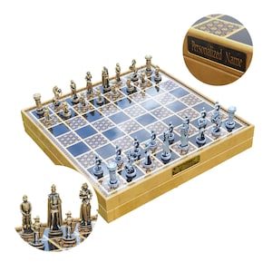 May include: A wooden chessboard with a black and gold design. The board is open and shows the chess pieces, which are made of metal and have a gold and silver finish. The board has a personalized nameplate on the side.