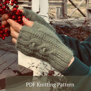 May include: Close-up of sage green fingerless gloves with a cable knit design. The gloves are made of a soft, textured yarn. The text "PDF Knitting Pattern" is displayed at the bottom of the image.