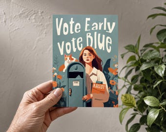 May include: A rectangular postcard featuring the text Vote Early Vote Blue in white lettering. The illustration depicts a person standing next to a blue US Mail collection box with an orange ballot envelope, a ginger cat, and orange flowers.