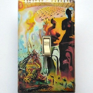 May include: A decorative light switch cover featuring a surrealist painting with figures and a landscape in shades of yellow, orange, blue, and red. The switch is off, with the word "OFF" visible. The cover has a glossy finish.